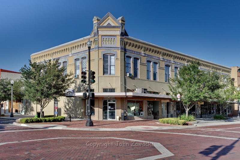 First Street_6601.jpg - Hotchkiss Block, Sanford, FLOne of the first two brick structures built in Sanford, FloridaThe original 1886 brick block at this location was destroyed by the great fire of 1887.Local legend has it that rubble from the first building was embedded in the pedimenton the corner of the roof of this Romanesque Revival building when it was constructedfor Frederick Hotchkiss in 1887.